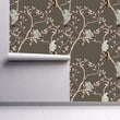 Load image into Gallery viewer, Grey Asian Chinoiserie bird botanical fabric peel and stick wallpaper on wall partially rolled up