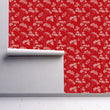 Load image into Gallery viewer, Red antique Victorian floral fabric peel and stick wallpaper on wall partially rolled up