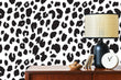 Load image into Gallery viewer, Black and white leopard print fabric peel and stick wallpaper with cabinet and lamp