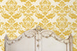 Load image into Gallery viewer, Antique Victorian gold damask fabric peel and stick wallpaper in room with antique bed