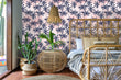 Load image into Gallery viewer, Vintage retro palm tree pink and blue fabric peel and stick wallpaper with bed, lamp and plant