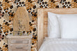 Load image into Gallery viewer, Tropical jungle palm leaves and cheetah print fabric peel and stick wallpaper in bedroom with bed and lamp