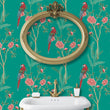 Load image into Gallery viewer, Blue botanical parrot Chinoiserie fabric peel and stick wallpaper in bathroom with gold mirror and sink