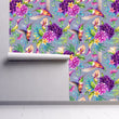 Load image into Gallery viewer, Purple and blue botanical floral hummingbird fabric peel and stick wallpaper on wall partially rolled up