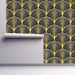 Load image into Gallery viewer, Black and gold geometric Art Deco fabric peel and stick wallpaper on wall partially rolled up