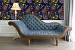 Load image into Gallery viewer, Blue and purple botanical floral hummingbird fabric peel and stick wallpaper with blue velvet sofa