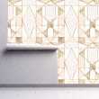 Load image into Gallery viewer, Gold and grey geometric antique Art Deco fabric peel and stick wallpaper on wall partially rolled up