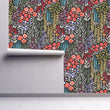 Load image into Gallery viewer, Dark floral botanical fabric peel and stick wallpaper on wall partially rolled up