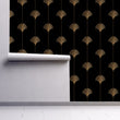 Load image into Gallery viewer, Black and gold vintage Art Deco geometric fabric peel and stick wallpaper on wall partially rolled up
