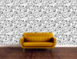 Load image into Gallery viewer, Black and white music notes fabric peel and stick wallpaper with orange sofa