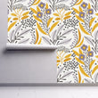Load image into Gallery viewer, Yellow and grey botanical floral fabric peel and stick wallpaper on wall partially rolled up