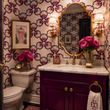 Load image into Gallery viewer, Reese Way wallpaper by Pickwick & Elm in a colorful Palm Beach powder room with a plum vanity, brass fixtures, marble countertop, and gold mirror.