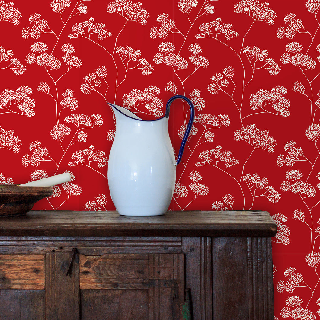 Red antique Victorian floral fabric peel and stick wallpaper in room with cabinet and water pitcher