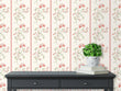 Load image into Gallery viewer, Pink vintage floral fabric peel and stick wallpaper with black table and plant
