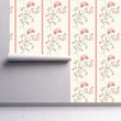 Load image into Gallery viewer, Pink vintage floral fabric peel and stick wallpaper on wall partially rolled up

