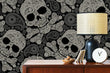Load image into Gallery viewer, Black and white gothic skull fabric peel and stick wallpaper with cabinet and lamp
