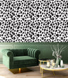 Load image into Gallery viewer, Black and white leopard print fabric peel and stick wallpaper in room with green chair and coffee table
