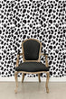 Load image into Gallery viewer, Black and white leopard print fabric peel and stick wallpaper with black chair
