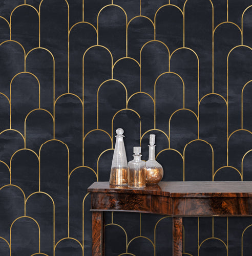 Moody dark Art Deco black and gold fabric peel and stick wallpaper in room with table and gold bottles