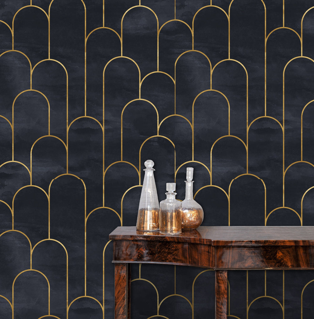 Moody dark Art Deco black and gold fabric peel and stick wallpaper in room with table and gold bottles