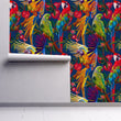 Load image into Gallery viewer, Bright eclectic tropical parrot fabric peel and stick wallpaper on wall partially rolled up
