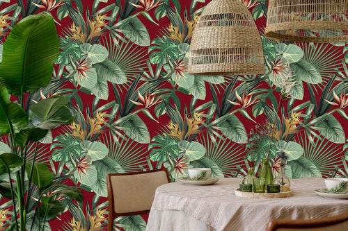 Burgundy and green palm leaves tropical fabric peel and stick wallpaper in dining room with table and plant
