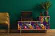 Load image into Gallery viewer, Bright eclectic tropical parrot fabric peel and stick wallpaper on vintage record player with plant and chair

