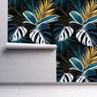 Load image into Gallery viewer, Dark botanical tropical palm leaves fabric peel and stick wallpaper on wall partially rolled up
