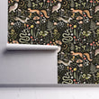 Load image into Gallery viewer, Dark cottage core mushroom and forest animals fabric peel and stick wallpaper on wall partially rolled up
