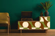 Load image into Gallery viewer, Green and brown vintage Mid-century Modern fabric peel and stick wallpaper on vintage record player with lamp and chair
