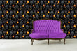 Load image into Gallery viewer, Black and orange Victorian gothic skull fabric peel and stick wallpaper with purple sofa
