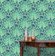 Load image into Gallery viewer, Vintage abstract blue Art Deco peacock fabric peel and stick wallpaper with table and gold jars
