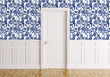 Load image into Gallery viewer, Blue cat and flower toile fabric peel and stick wallpaper on wall with door

