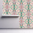 Load image into Gallery viewer, Victorian antique pink floral damask fabric peel and stick wallpaper on wall partially rolled up
