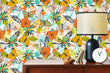 Load image into Gallery viewer, Orange and yellow vintage retro tropical butterfly garden fabric peel and stick wallpaper on a cabinet with lamp and clock
