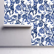 Load image into Gallery viewer, Blue cat and flower toile fabric peel and stick wallpaper on wall partially rolled up
