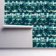 Load image into Gallery viewer, Blue coastal tropical palm trees fabric peel and stick wallpaper on wall partially rolled up
