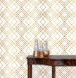 Load image into Gallery viewer, Gold antique geometric Art Deco fabric peel and stick wallpaper with table and gold jars
