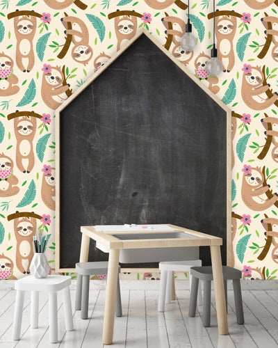 Cute tropical sloth kid's fabric peel and stick wallpaper in playroom with chalk board