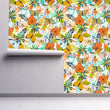 Load image into Gallery viewer, Orange and yellow vintage retro tropical butterfly garden fabric peel and stick wallpaper on wall partially rolled up
