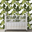 Load image into Gallery viewer, Green tropical palm leaves fabric peel and stick wallpaper with crib in nursery
