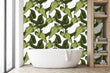 Load image into Gallery viewer, Green tropical palm leaves fabric peel and stick wallpaper in bathroom with bathtub and shelf
