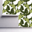 Load image into Gallery viewer, Green tropical palm leaves fabric peel and stick wallpaper on wall partially rolled up
