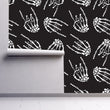 Load image into Gallery viewer, Hand bones gothic black and white fabric peel and stick wallpaper on wall paratially rolled up
