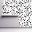 Load image into Gallery viewer, Black and white music notes fabric peel and stick wallpaper on wall partially rolled up
