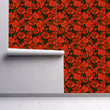 Load image into Gallery viewer, Black and red dark floral gothic fabric peel and stick wallpaper on wall partially rolled up
