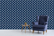 Load image into Gallery viewer, Navy blue and white nautical coastal fish swimming fabric peel and stick wallpaper with blue chair and table
