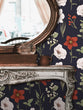 Load image into Gallery viewer, Victorian antique dark floral fabric peel and stick wallpaper with table and mirror

