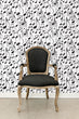 Load image into Gallery viewer, Black and white music notes fabric peel and stick wallpaper with black chair
