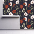 Load image into Gallery viewer, Victorian antique dark floral fabric peel and stick wallpaper on wall partially rolled up

